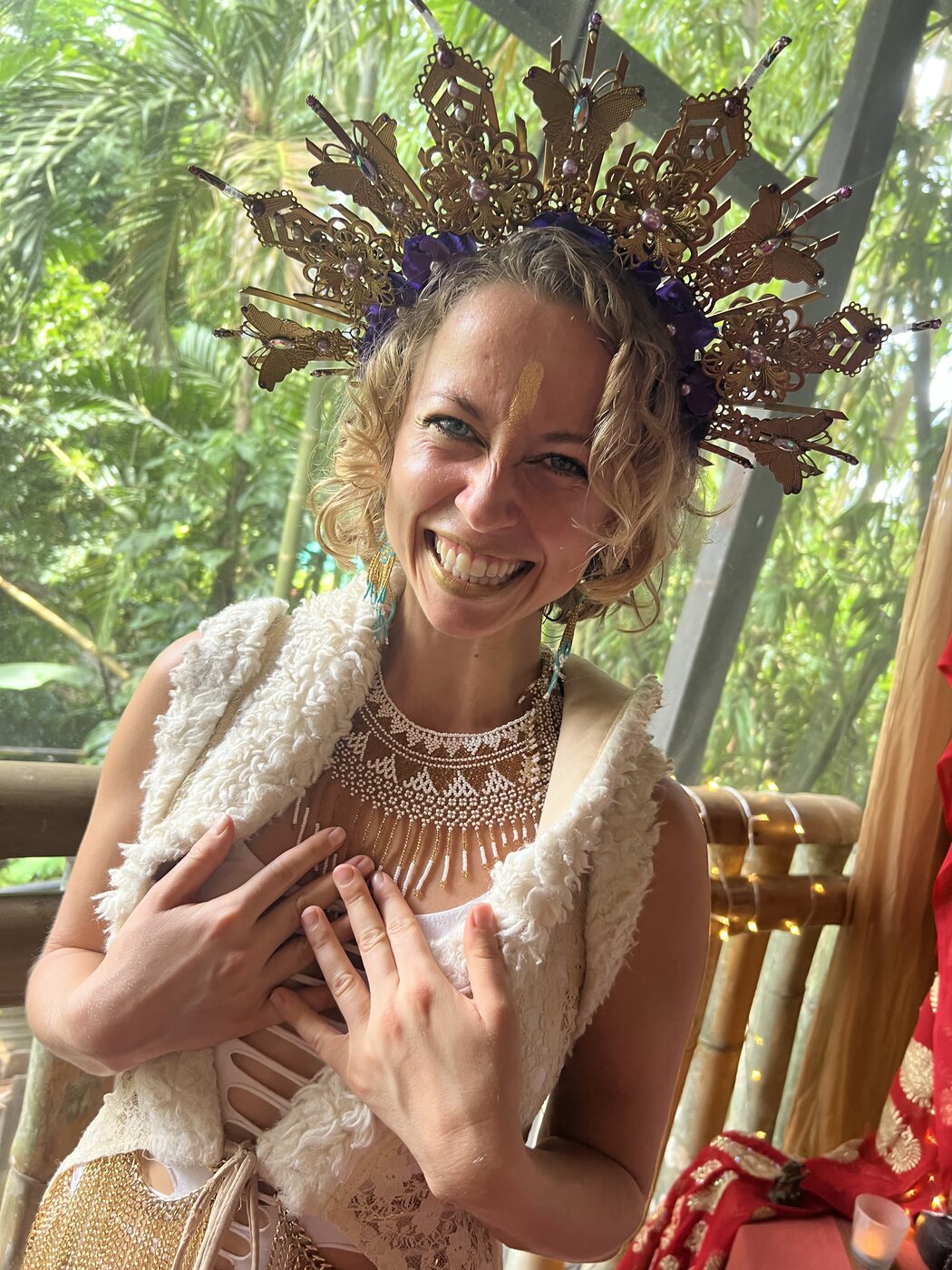 Skylar with hand at her throat, eyes closed, in a garden