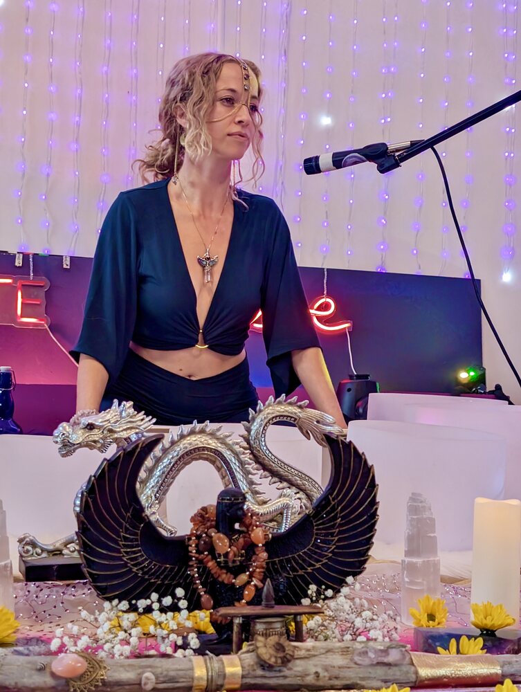 Skylar speaking at a ceremonial altar with neon light accents